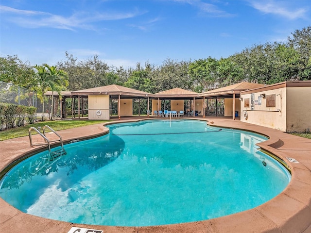 pool featuring a patio area and fence