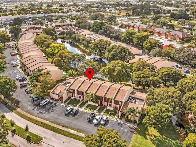 birds eye view of property with a residential view and a water view