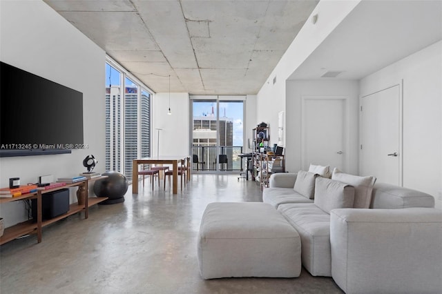 living room with concrete floors and a wall of windows