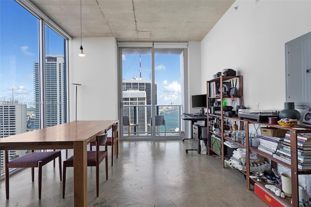 dining area featuring concrete floors and floor to ceiling windows