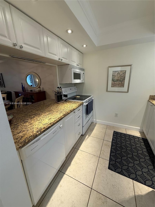 kitchen featuring white cabinets, crown molding, dark stone counters, white appliances, and light tile patterned floors