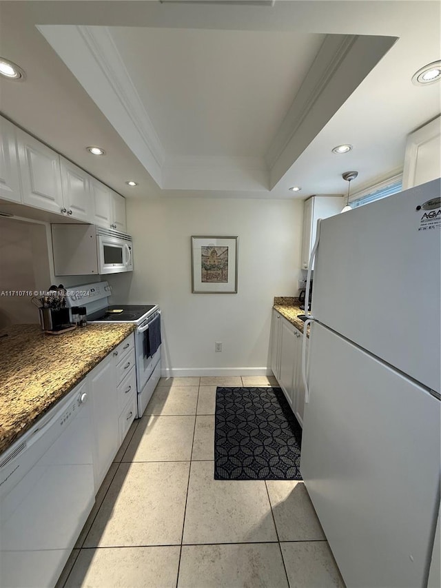 kitchen with white cabinets, light tile patterned floors, white appliances, and a raised ceiling