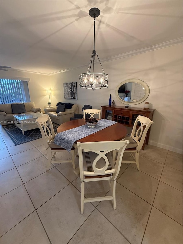 dining room with light tile patterned floors, an inviting chandelier, and crown molding