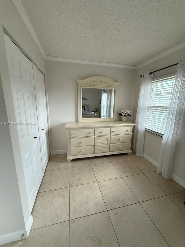 bathroom featuring crown molding, tile patterned flooring, vanity, and a textured ceiling