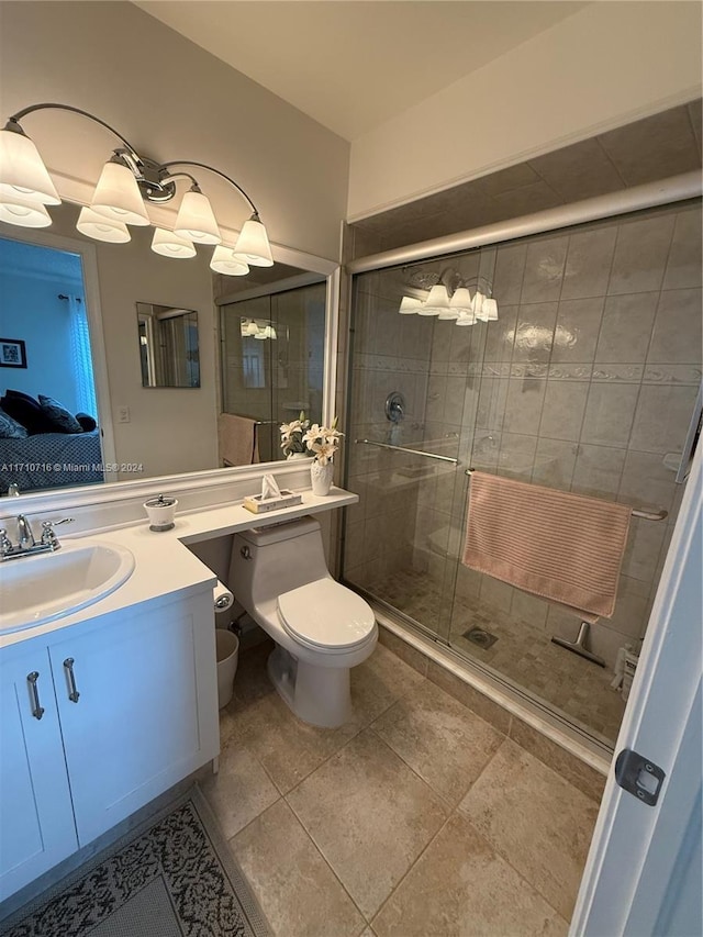 bathroom with tile patterned floors, vanity, toilet, and walk in shower