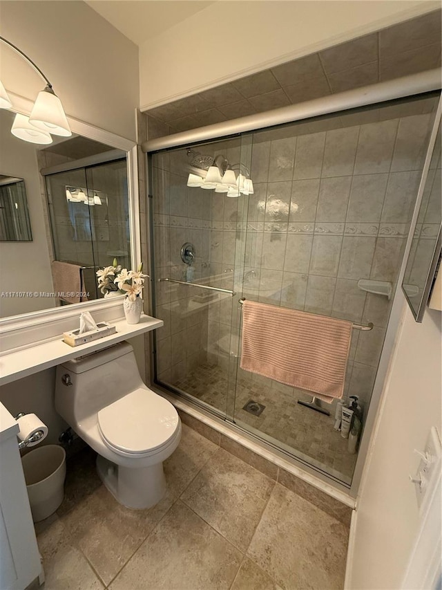 bathroom with an enclosed shower, tile patterned flooring, and toilet