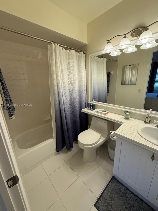 full bathroom with tile patterned floors, vanity, toilet, and shower / bath combo with shower curtain