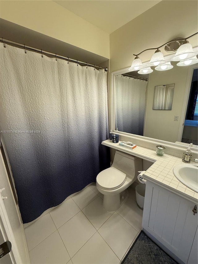 bathroom featuring tile patterned flooring, vanity, and toilet