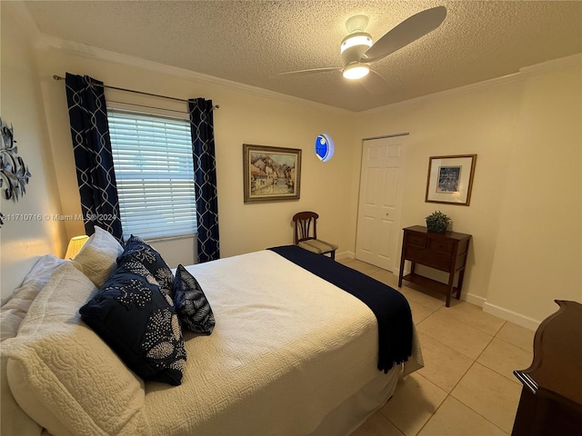 tiled bedroom featuring ceiling fan, crown molding, and a textured ceiling