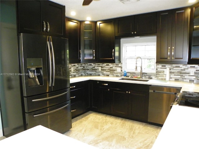 kitchen featuring decorative backsplash, stainless steel appliances, ceiling fan, and sink