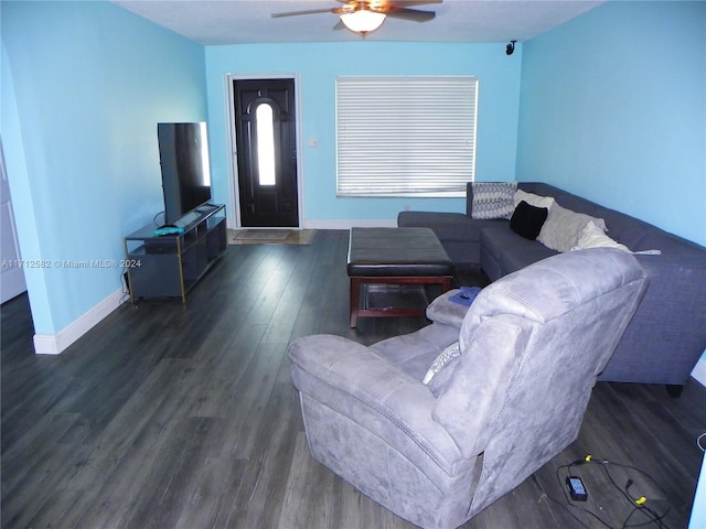 living room featuring ceiling fan and dark hardwood / wood-style flooring