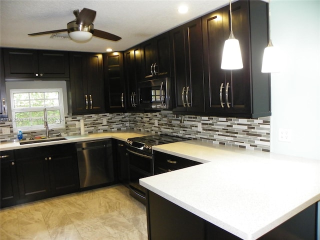 kitchen with kitchen peninsula, appliances with stainless steel finishes, ceiling fan, sink, and hanging light fixtures