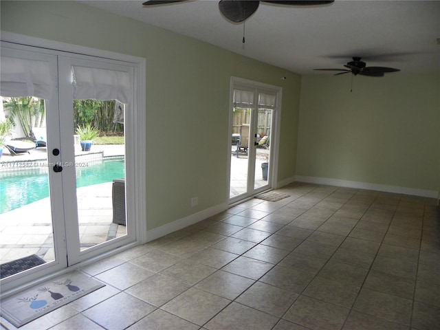 doorway with french doors, light tile patterned floors, plenty of natural light, and ceiling fan