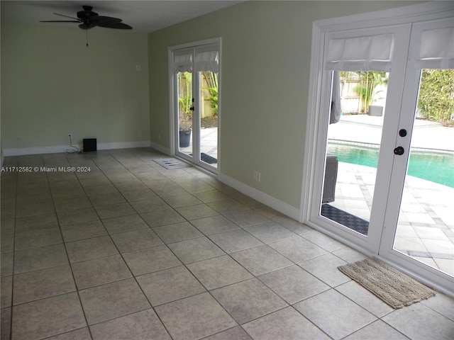 spare room featuring ceiling fan, french doors, and light tile patterned floors