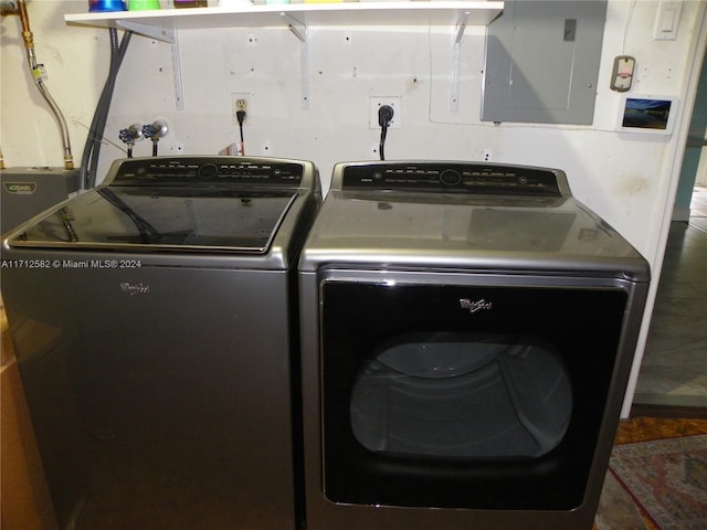 clothes washing area with electric panel and washing machine and clothes dryer