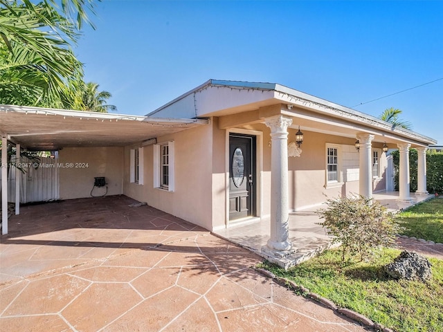 exterior space featuring a carport