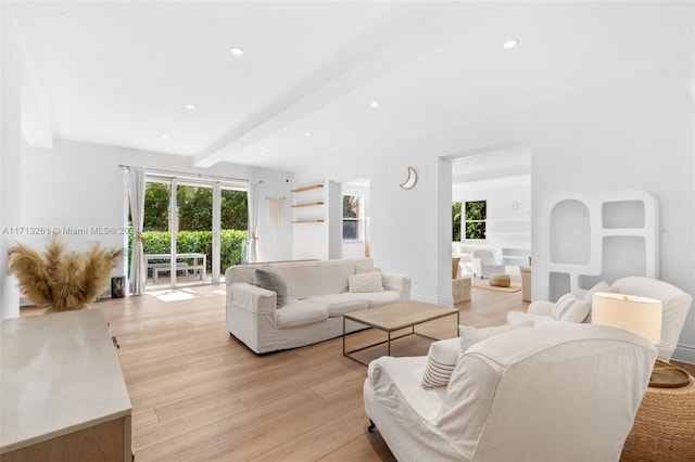 living room featuring beam ceiling and light hardwood / wood-style flooring