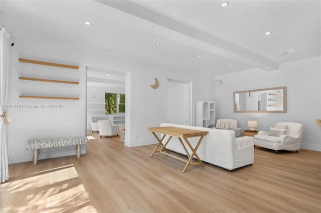 sitting room featuring beamed ceiling and light hardwood / wood-style floors