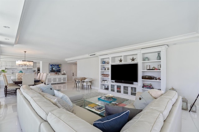 living room featuring an inviting chandelier and crown molding