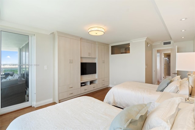 bedroom featuring hardwood / wood-style floors and crown molding