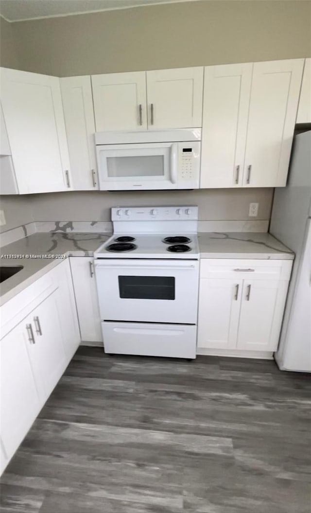 kitchen featuring white cabinetry, white appliances, and dark wood-type flooring