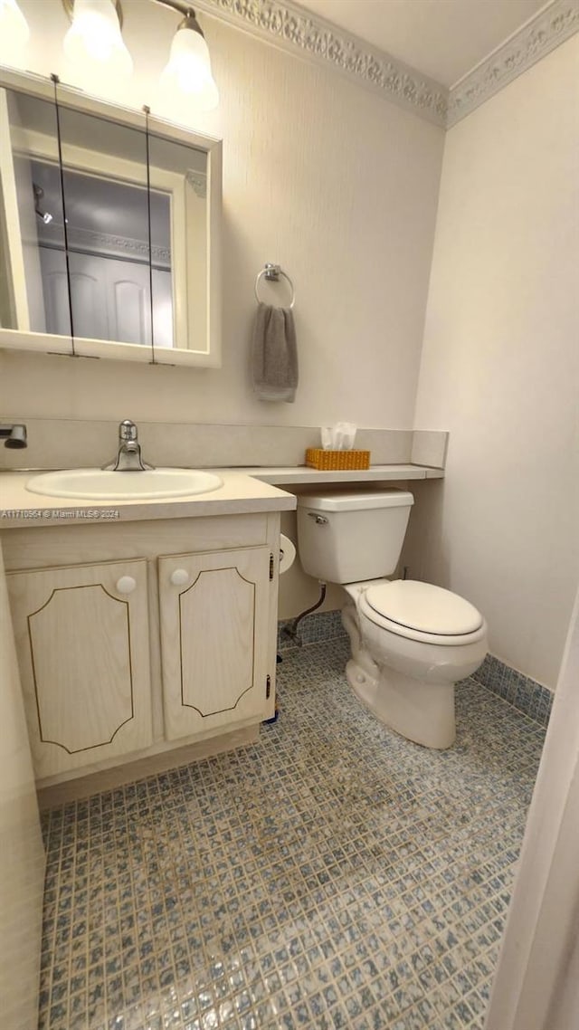 bathroom with tile patterned floors, vanity, and toilet