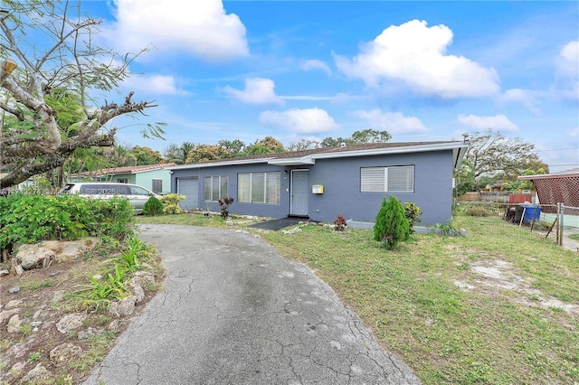 view of front facade with a front yard and a garage