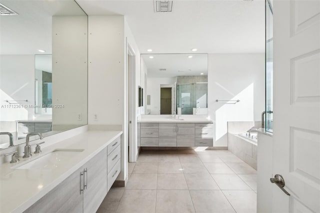 bathroom featuring vanity, tile patterned flooring, and plus walk in shower