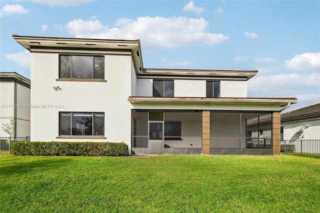 back of house with a lawn and a sunroom