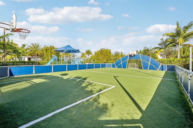 exterior space featuring a playground and basketball court