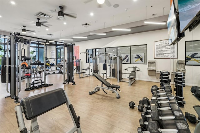 gym featuring ceiling fan and light wood-type flooring