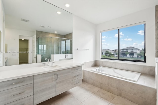 bathroom with tile patterned flooring, vanity, and independent shower and bath