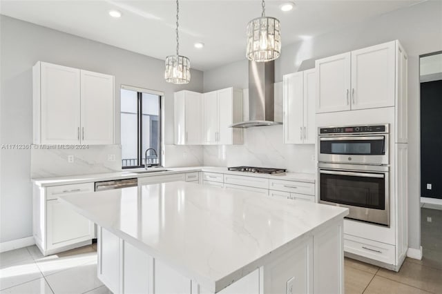 kitchen with white cabinets, a center island, and sink