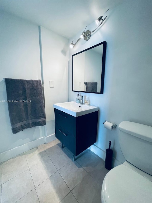 bathroom with tile patterned flooring, vanity, and toilet