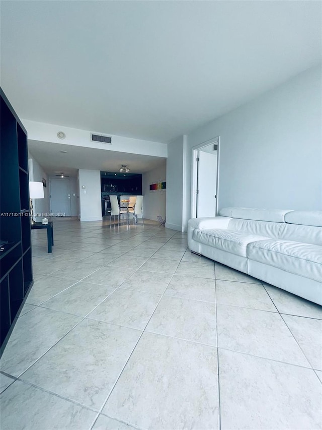 unfurnished living room with tile patterned floors