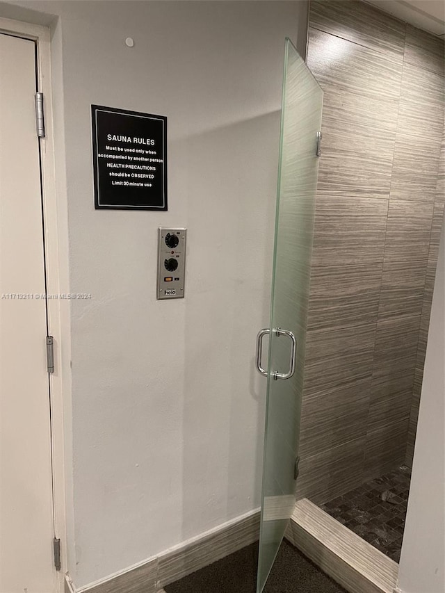 bathroom with a shower with shower door