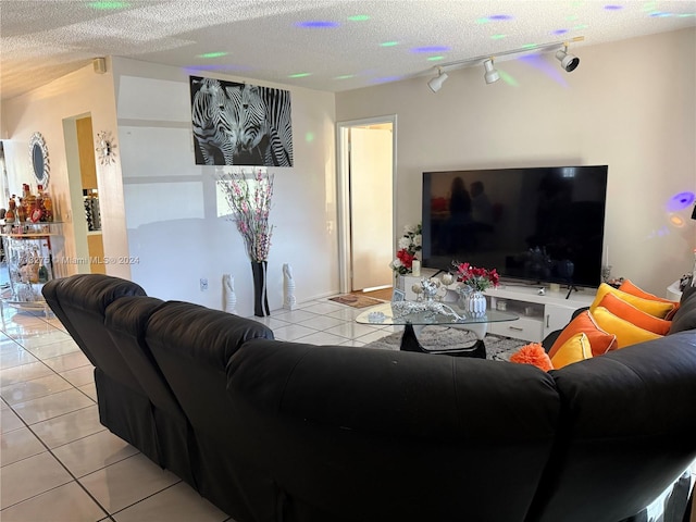 living room featuring light tile patterned floors, a textured ceiling, and rail lighting