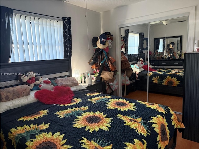 bedroom with wood-type flooring and a closet