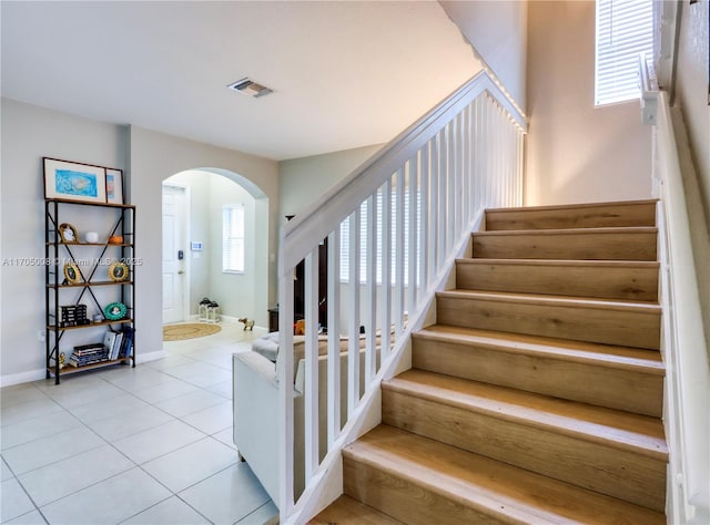 stairway featuring tile patterned flooring