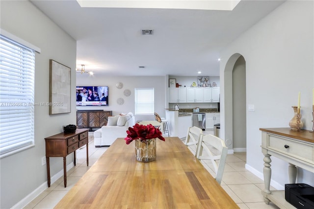 tiled dining room with plenty of natural light