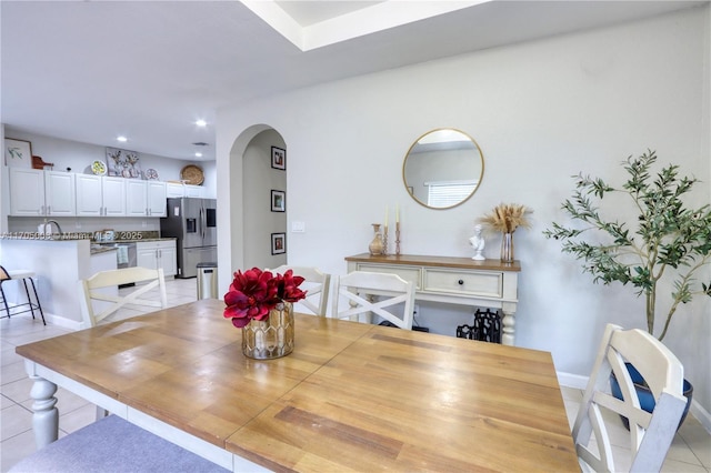 dining room featuring sink and light tile patterned flooring