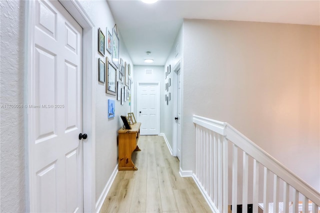 corridor featuring light hardwood / wood-style floors