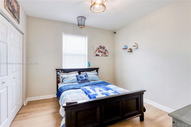 bedroom featuring light wood-type flooring and a closet