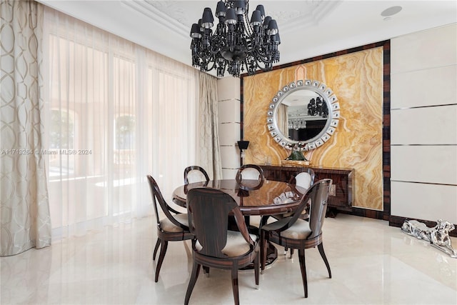 dining area featuring crown molding and an inviting chandelier