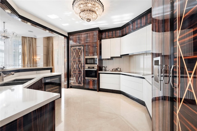 kitchen featuring sink, a notable chandelier, dark brown cabinets, stainless steel appliances, and beverage cooler