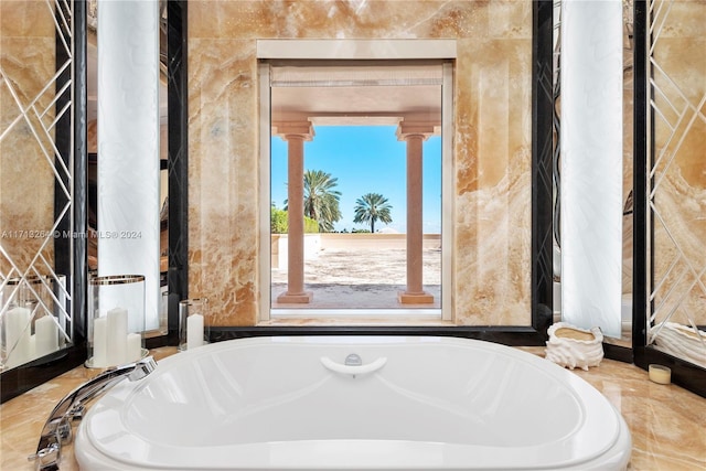 interior space featuring a tub to relax in and ornate columns