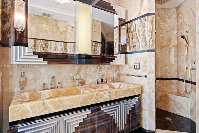 bathroom with tiled shower and vanity