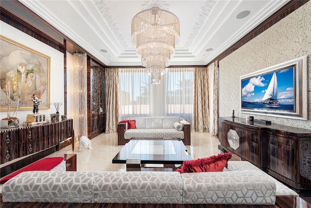 living room featuring a notable chandelier, a raised ceiling, ornamental molding, and light hardwood / wood-style flooring