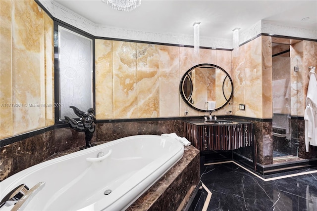 bathroom featuring vanity and a relaxing tiled tub