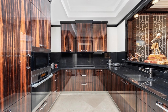 kitchen with ornamental molding, dark stone counters, black electric cooktop, sink, and oven